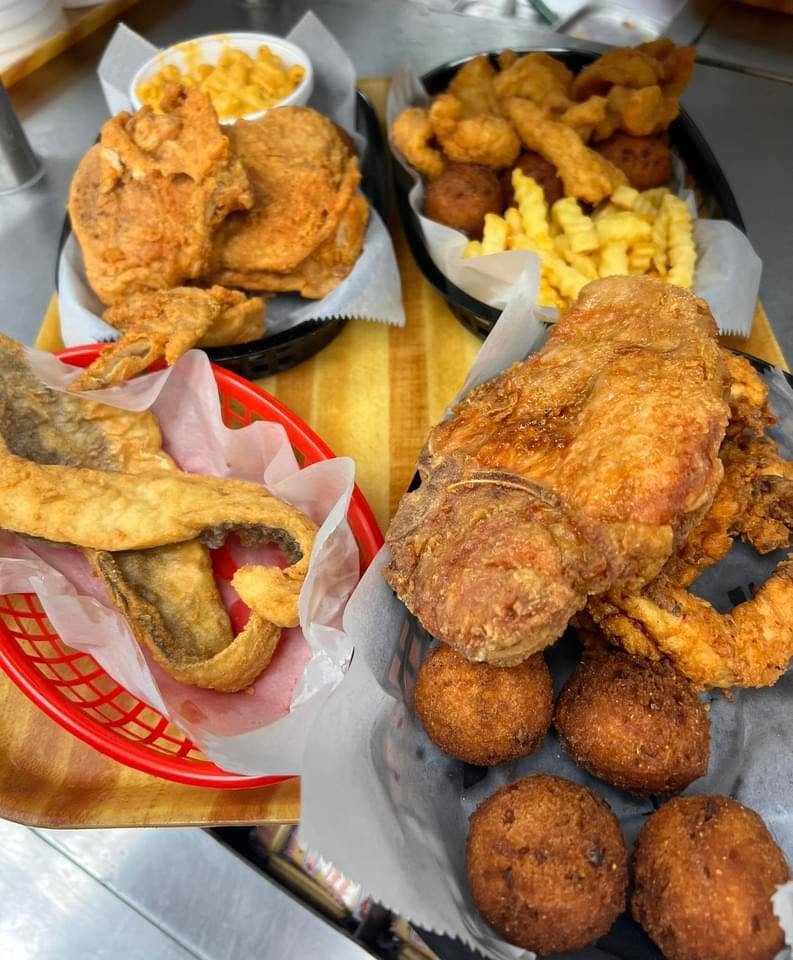 Loaded basket of fried chicken, popcorn shrimp, hushpuppies, fries and mac and cheese at Maryland Fried Chicken