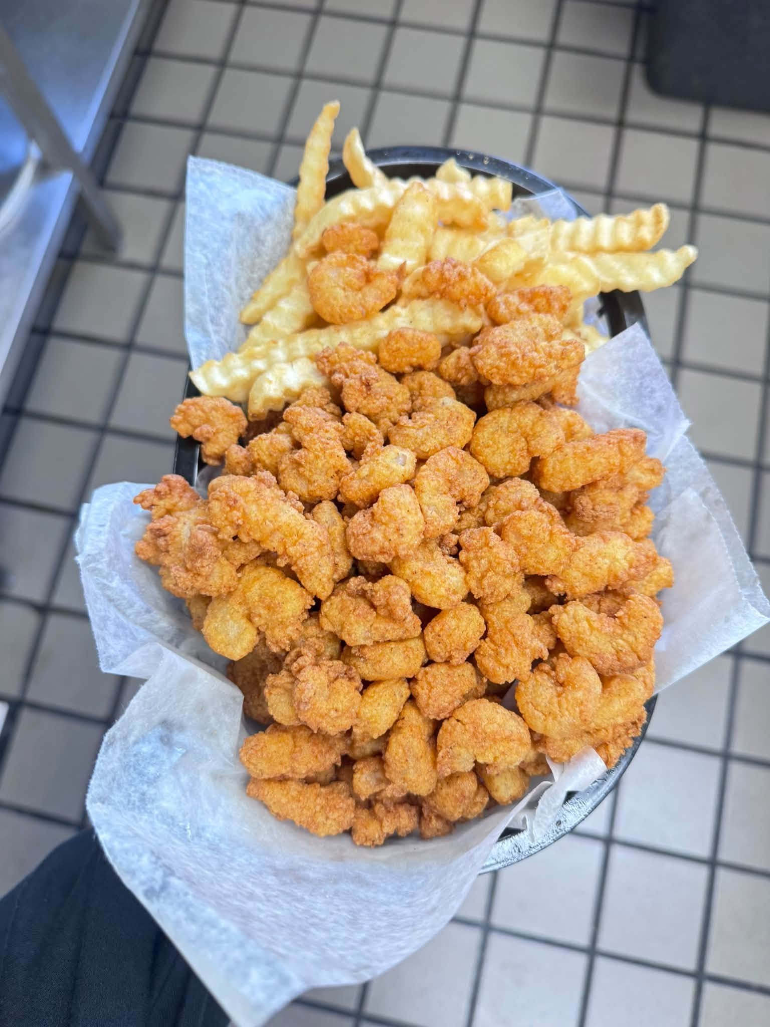 Basket of popcorn shrimp and crinkle fries